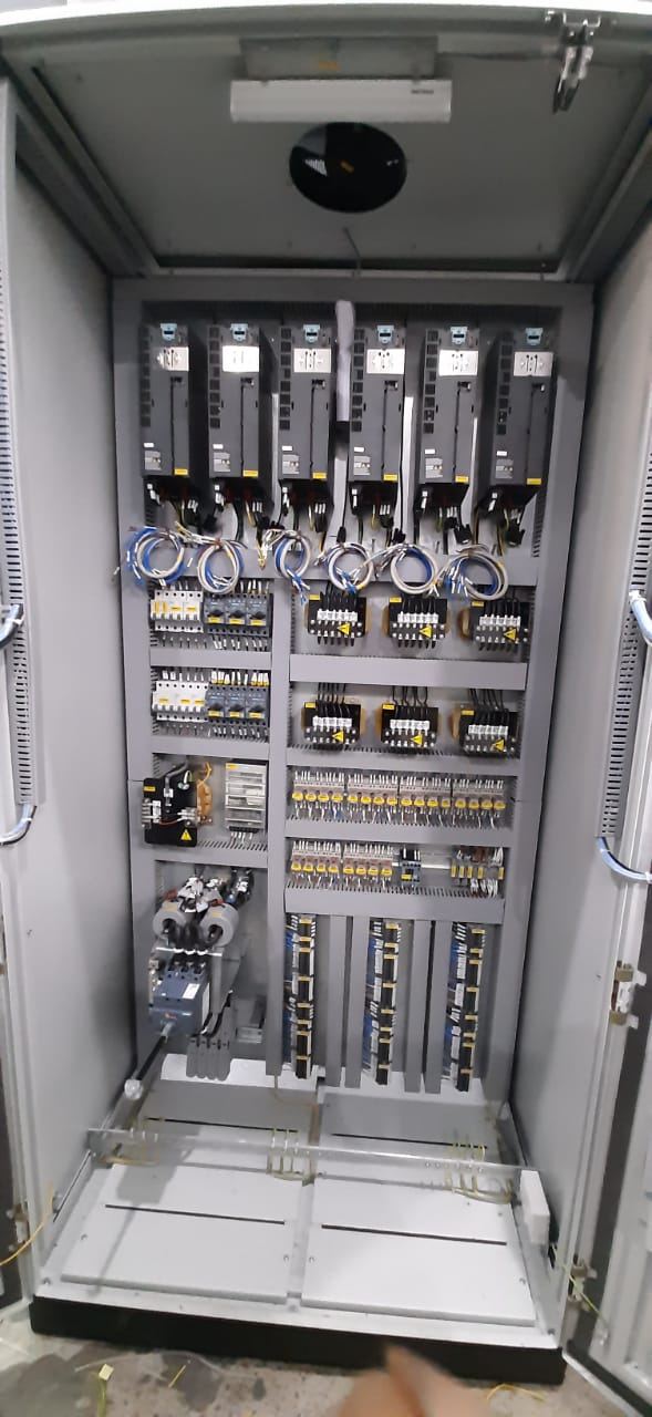Open panel with a row of servo drives above contactors